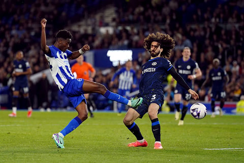 Simon Adingra, left, shoots a ball